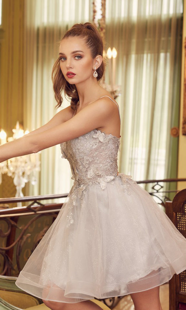 A woman in the Short A-Line Butterfly Homecoming Dress 902 stands indoors by ornate railings and large windows with sheer curtains.